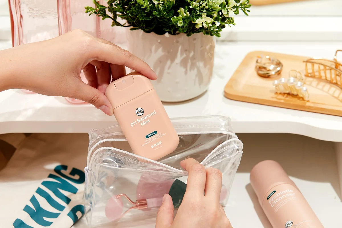 Packing an Ease pH balanced mist into a clear travel pouch